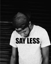 Load image into Gallery viewer, Say Less T Shirt on Model looking down Black and white picture